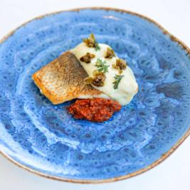 Sea bass with pebrereta tallà (chopped pepper), caper pil-pil and crispy blossoms